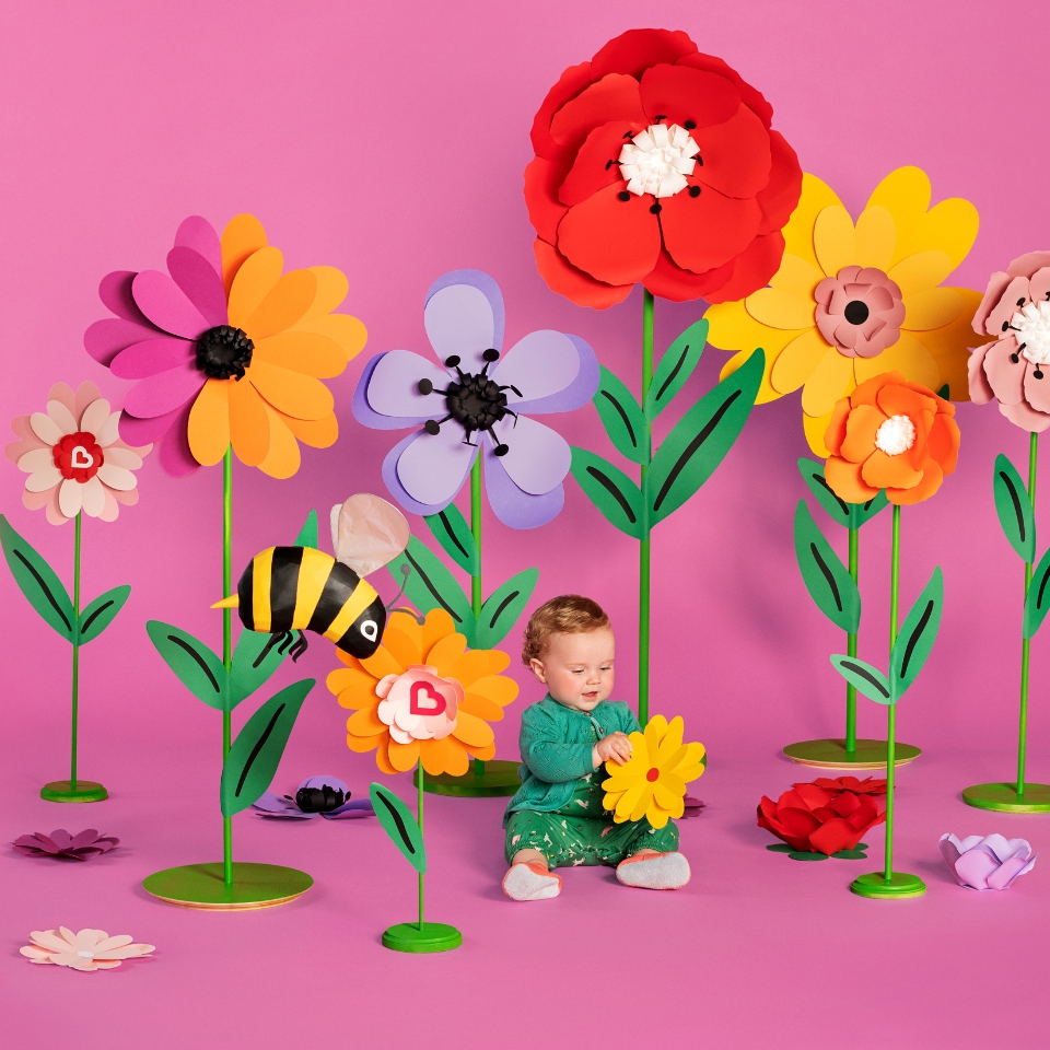 Kids sitting in flowers Cover Image